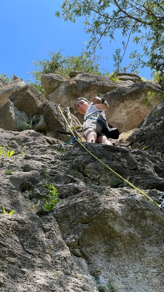 Me at the top of my first ever lead climb, setting up the top rope so I could safely clean the route on the way down. Photo: Andrew Holowaty (2022)